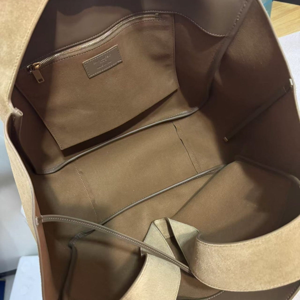 Interior view showing suede lining and zip pocket of the Golden Leaf nubuck tote bag.