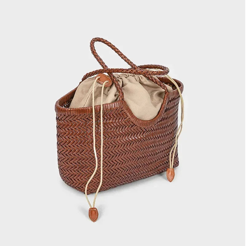 Brown woven handbag with drawstring on a light gray background