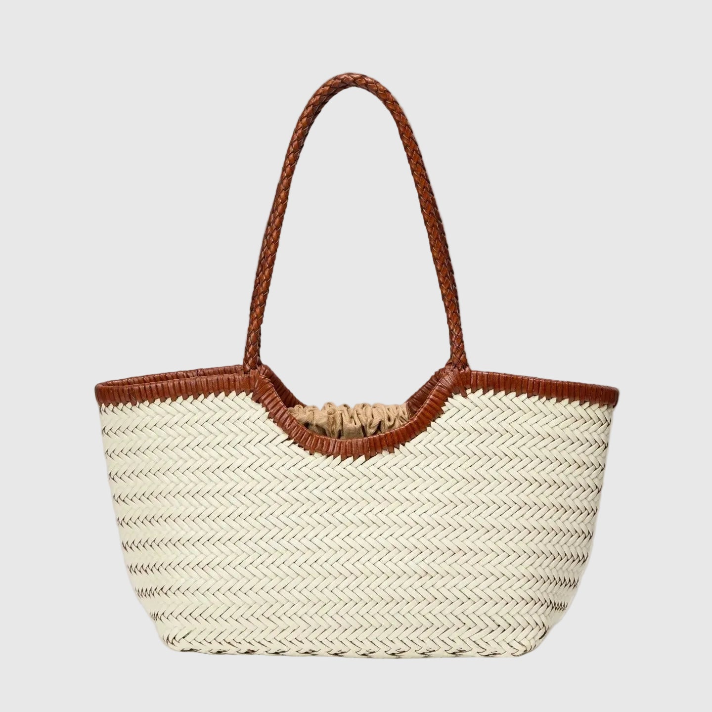 Woven handbag off white with brown handle on a light gray background
