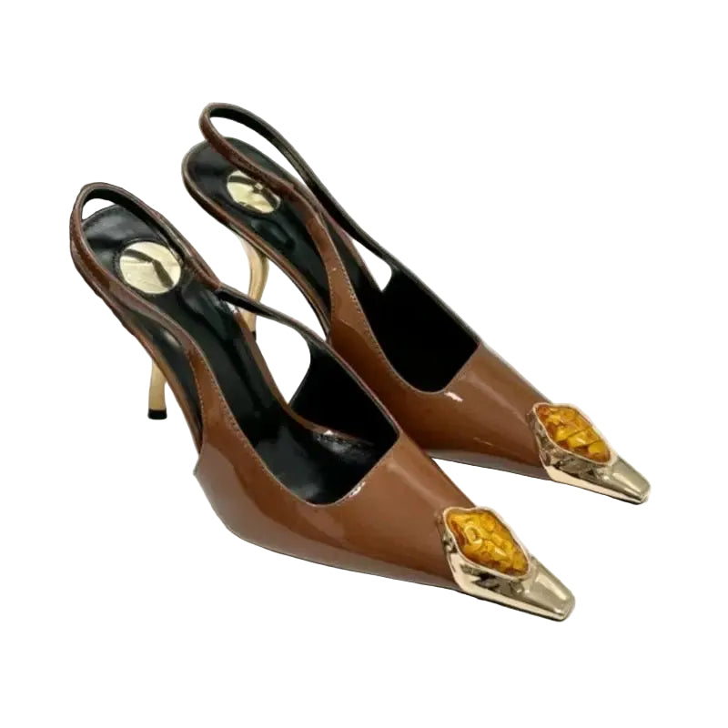 Brown high-heeled shoes with gold accents on a white surface