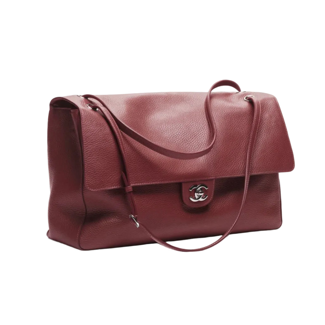 Burgundy handbag with a visible brand logo on a white background