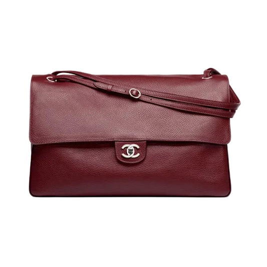 Burgundy handbag with a visible brand logo on a white background