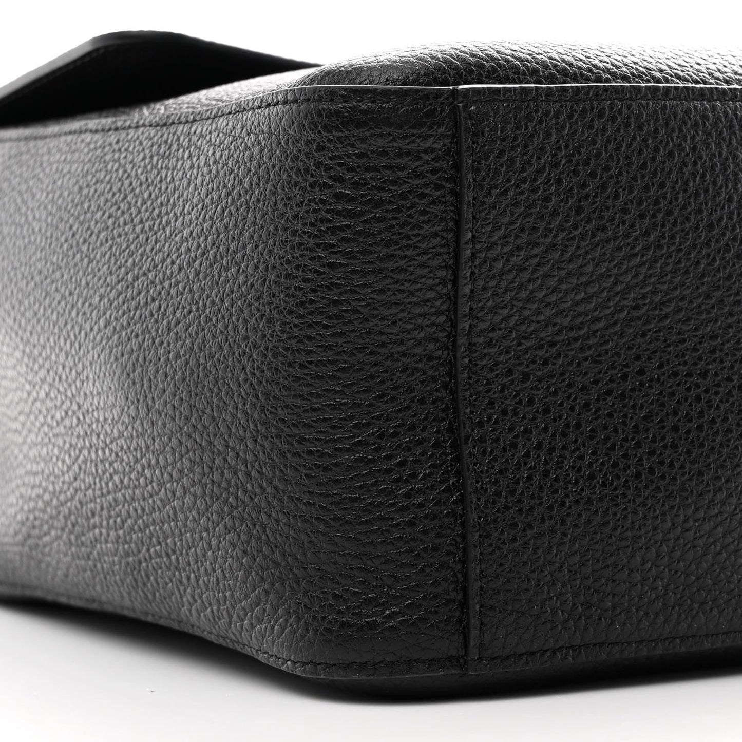 Close-up of a black leather product on a white background