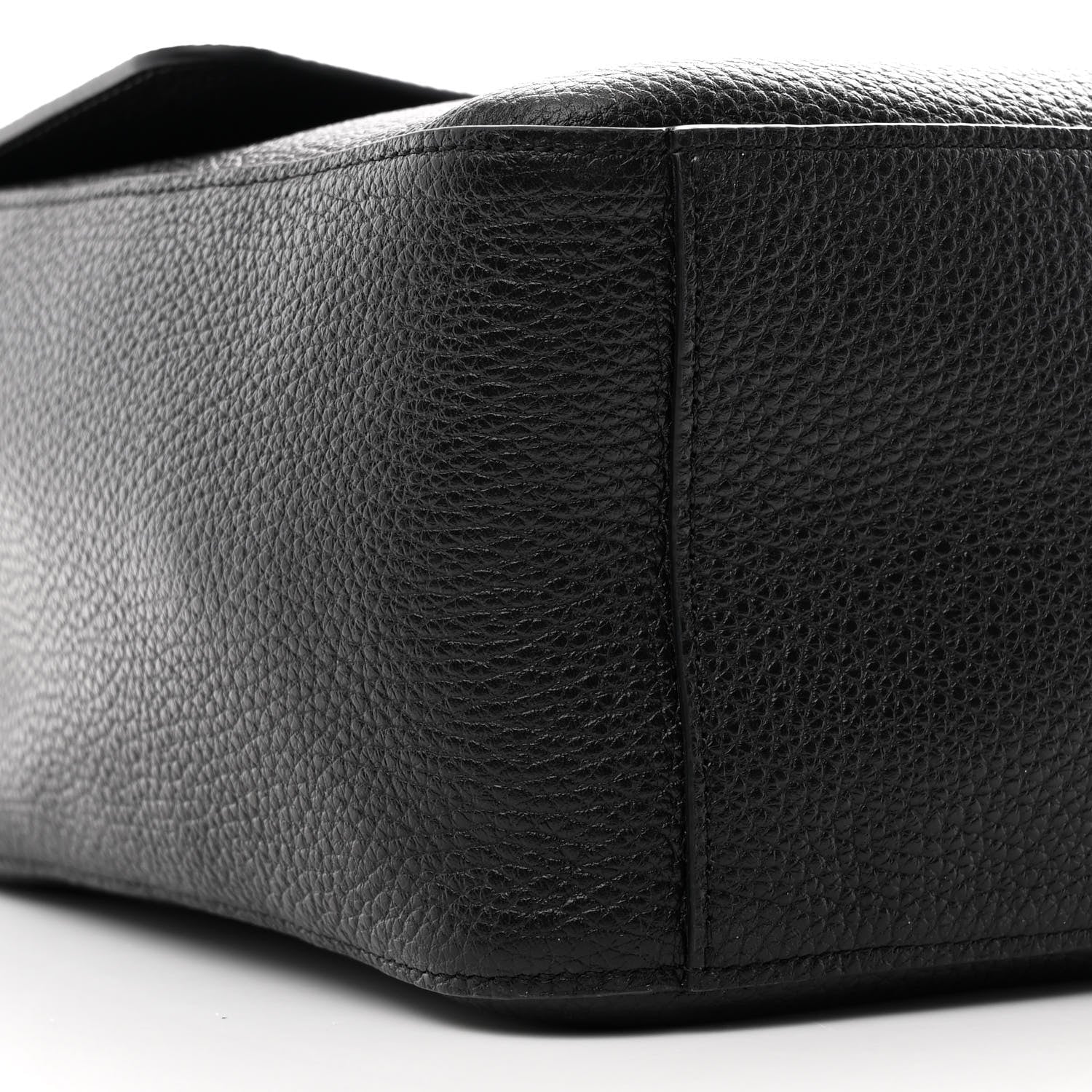 Close-up of a black leather product on a white background