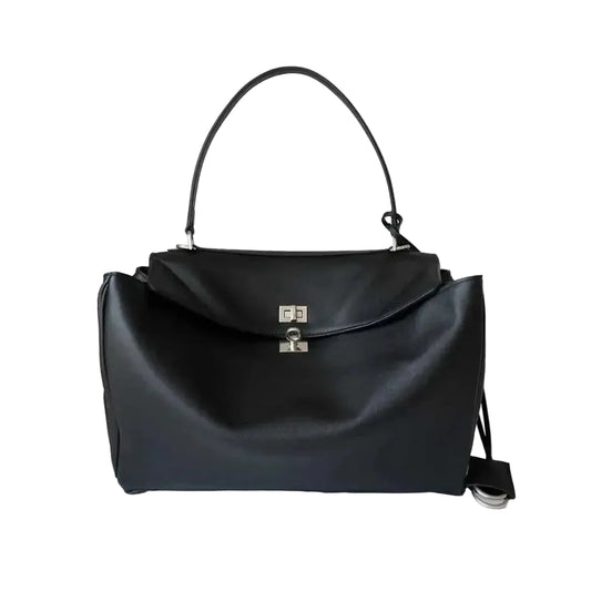 A black leather handbag with a top handle and a silver-tone metal clasp on a plain white background.