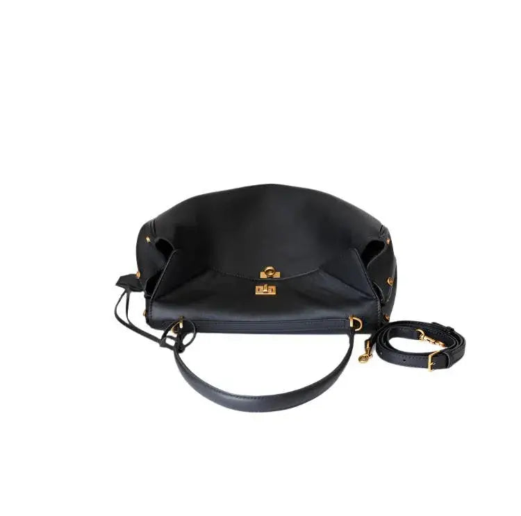 Black handbag with gold accents on a white background