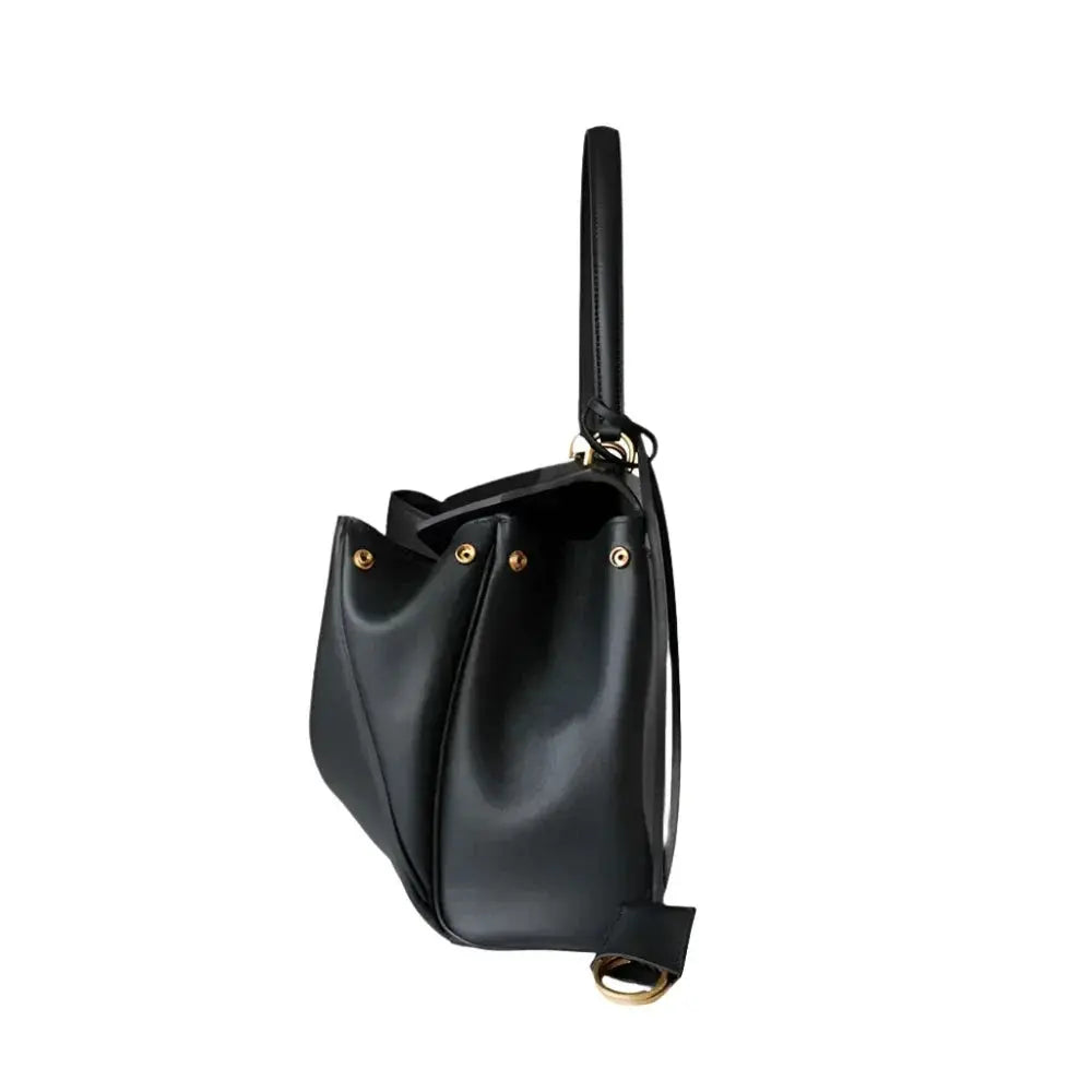 Black handbag with gold accents on a white background