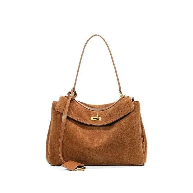 Brown handbag with a strap on a white background