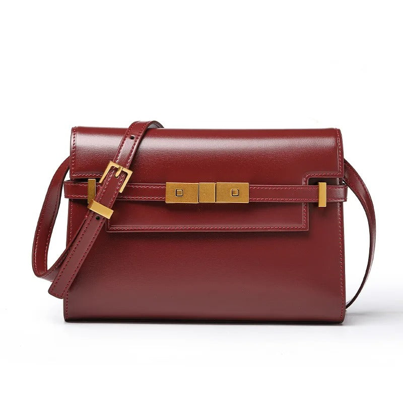 Burgundy handbag with gold accents on a white background