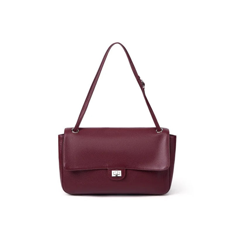 A burgundy pebbled leather shoulder bag with a front flap and silver-tone hardware, shown against a plain white background.