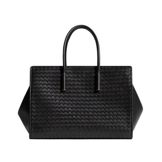 A black woven leather tote bag with double top handles, photographed against a clean, light gray studio background.